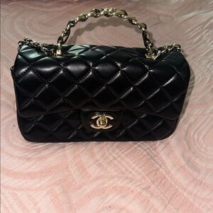 CHANEL Black Mini Bag with Gold Accents
